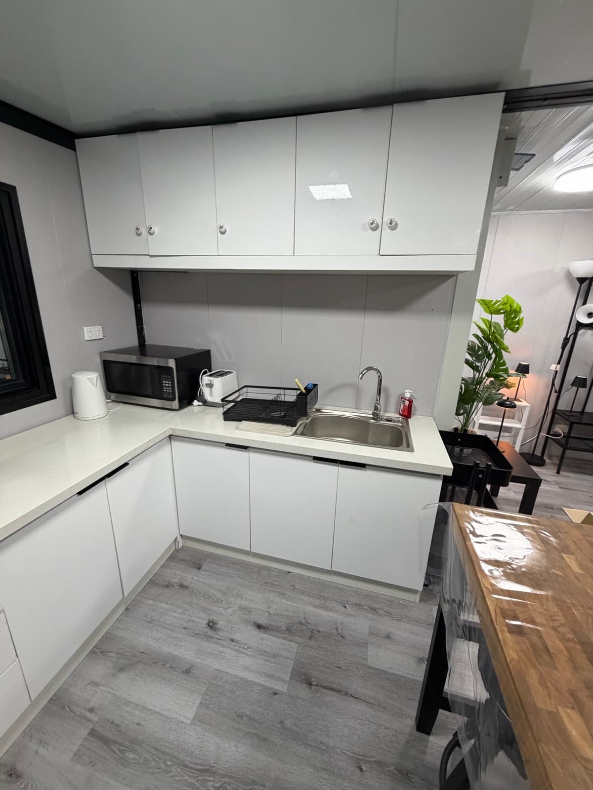 Fully equipped kitchen with microwave, toaster, and kettle
