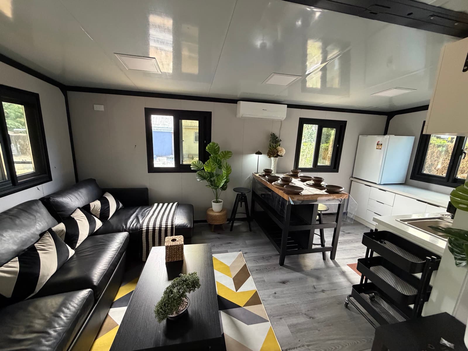 Living room with leather sectional and dining island