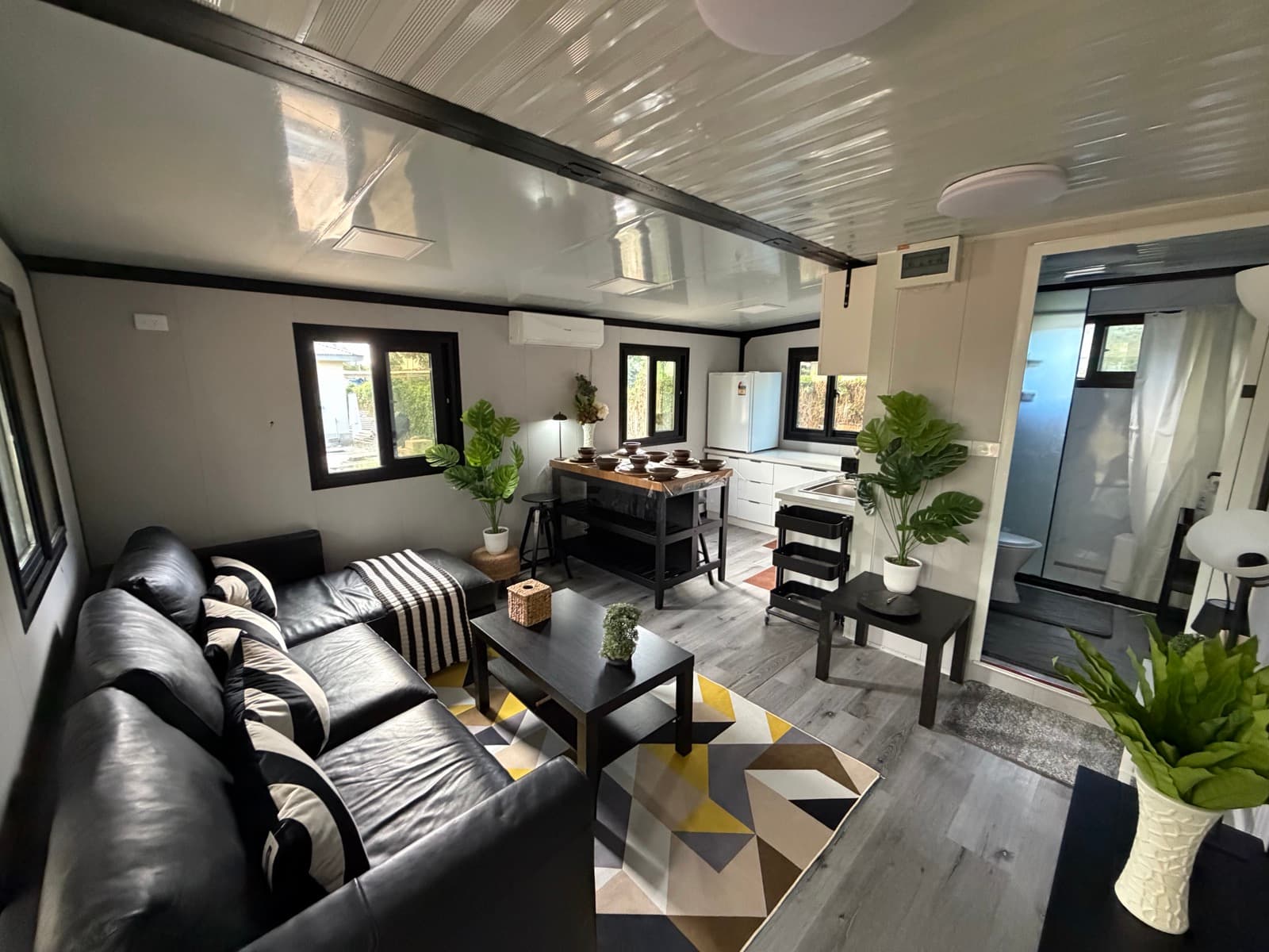 Open-plan living area with sectional sofa and kitchen